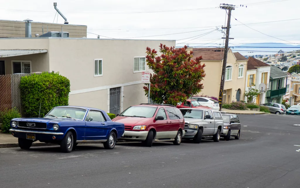 A 1966 Ford Mustang (like mine) is parked on a street in Daly City.