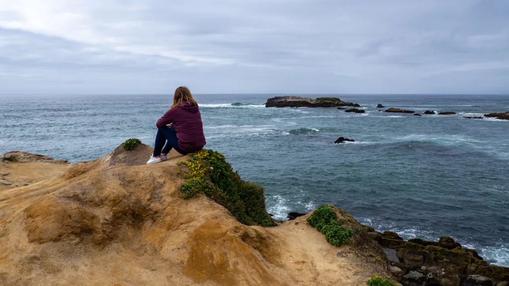 Sarah contemplates the ocean along Route 1.