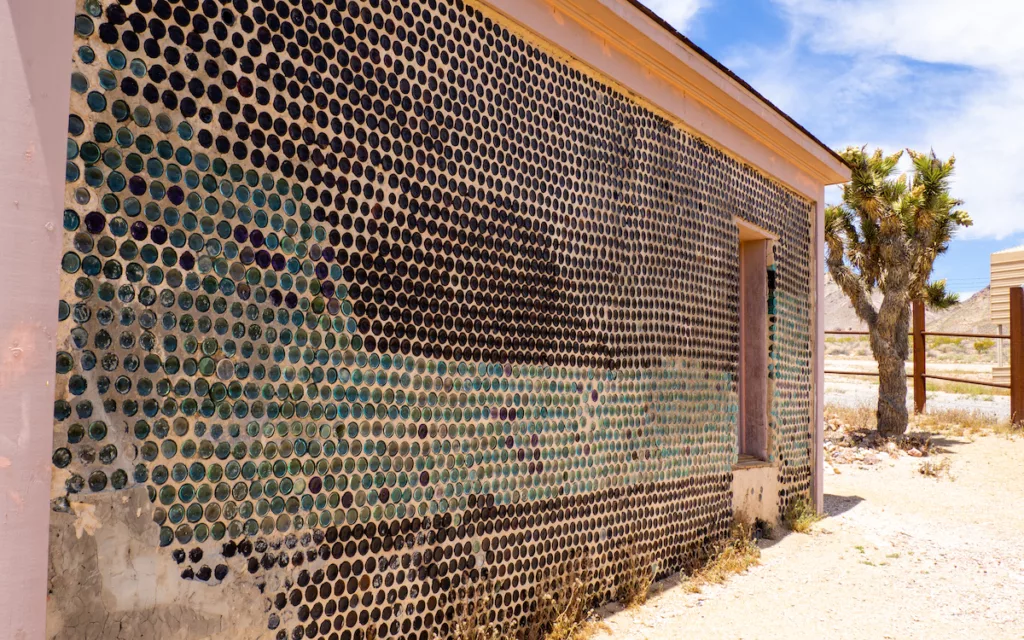 The Tom Kelly Bottle House is made of glass bottles and mortar.