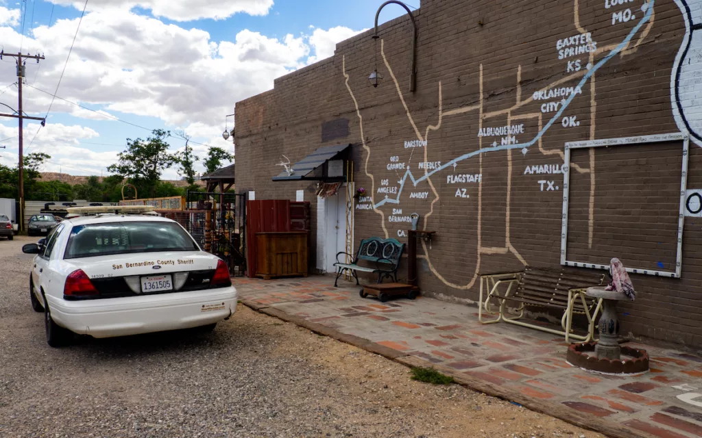 The county sheriff's car pulls up right in front of us in Oro Grande.