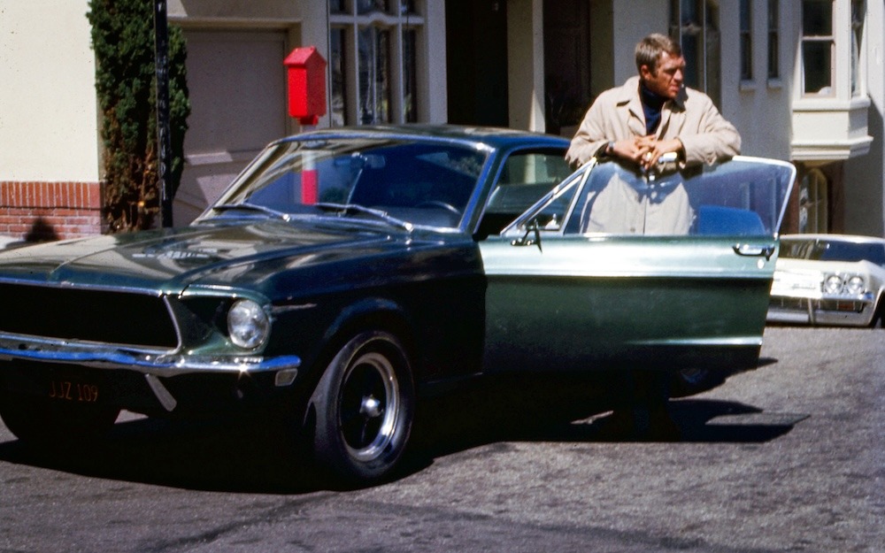 Frank Bullitt à la portière de son fastback 68 au croisement des rues Taylor et Broadway.